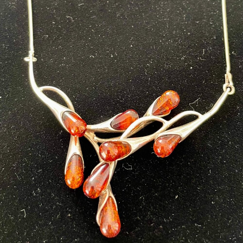 silver and amber colored stone necklace